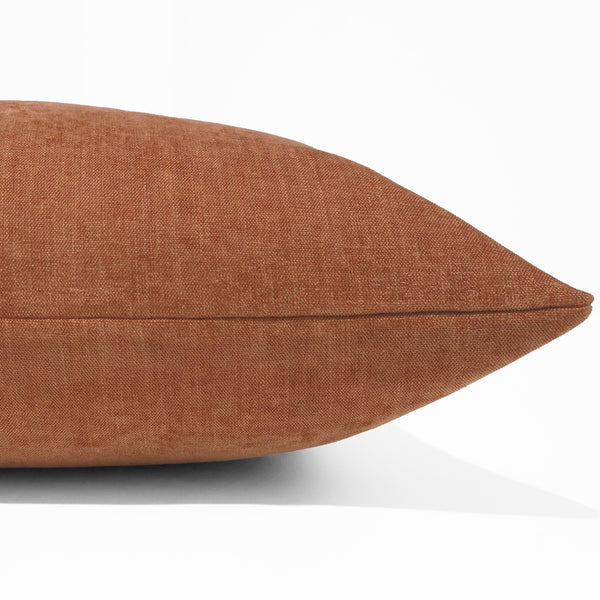 Rust velveteen pillow cover with soft woven texture, front corner detail