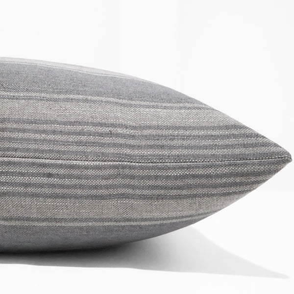 Blue Heron Stripe Pillow Cover featuring woven blue-gray stripes on a natural linen-look fabric with classic grain sack inspired styling for coastal and luxury interiors. Side view of Throw Pillow. 