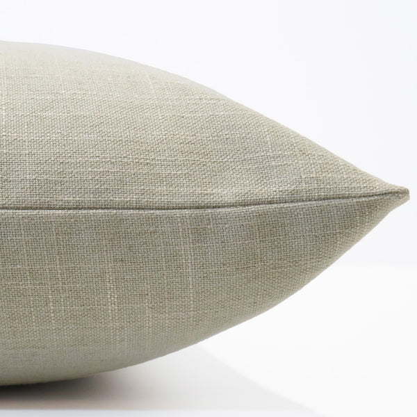 Textured taupe pillow on a white background