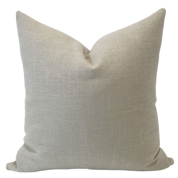 Beige pillow with a textured surface on a white background