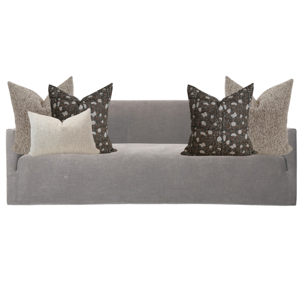 Gray sofa with decorative pillows on a white background
