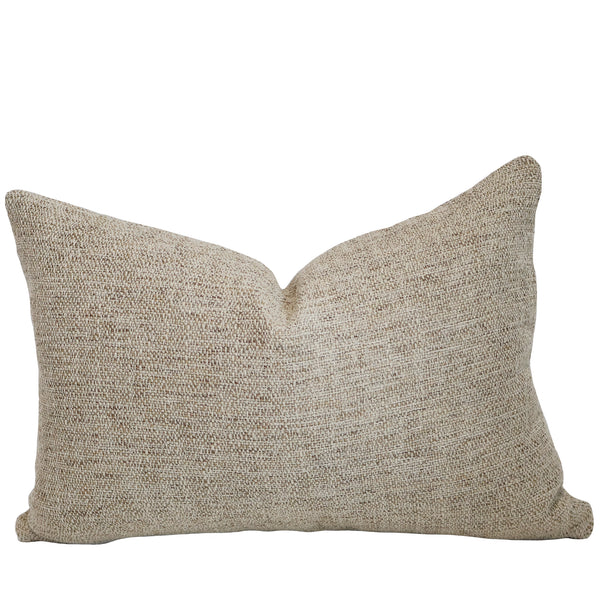 Gold Kissed woven lumbar indoor/outdoor pillow cover in warm beige performance fabric for coastal living rooms, patios, bedrooms, and luxury home decor.
