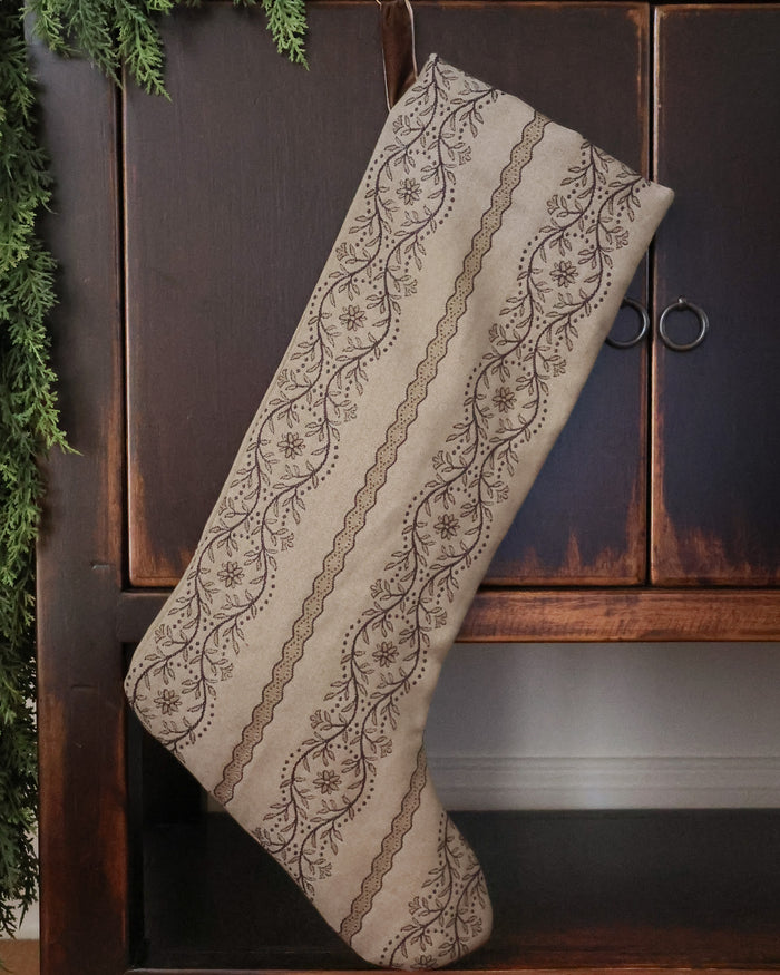HACKNER HOME luxury handmade Christmas stocking in neutral woven tapestry fabric with intricate floral vine pattern, featuring a minimal silhouette and heirloom-inspired design.