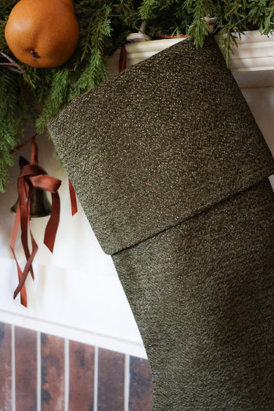 Close-up of HACKNER HOME dark olive green Christmas stocking featuring a tailored cuff, plush woven texture, and subtle golden threads.