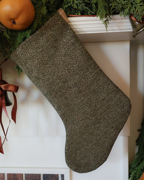 Handmade dark olive green Christmas stocking by HACKNER HOME featuring richly textured woven fabric with subtle golden flecks and a Boho, minimalist design.