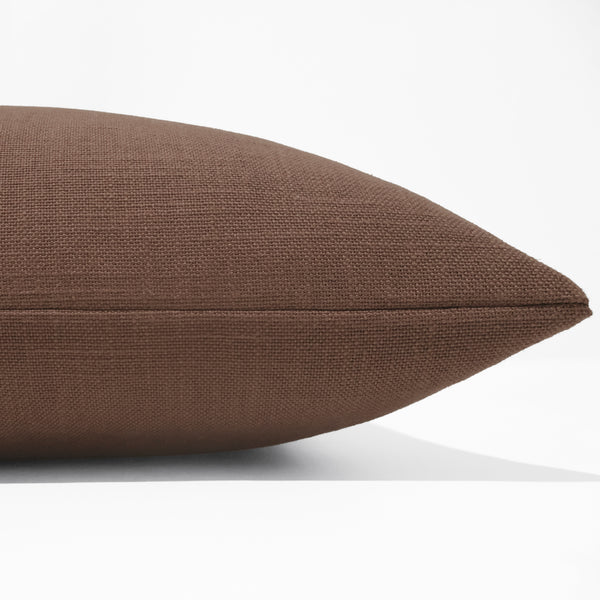 Side view of sienna brown pillow cover showing clean flat seam and fine woven linen-look texture