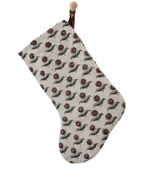 Boho Design linen block print Christmas stocking with a rounded foot, burgundy and olive floral pattern and a rust velvet hanging loop, shown on a white background