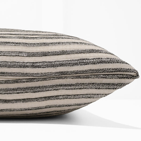 Salt Meadow Stripe Indoor/Outdoor Pillow Cover in ivory and charcoal striped indoor/outdoor performance upholstery fabric, handmade by Hackner Home for luxury coastal and modern home décor. Side view of cushion cover.