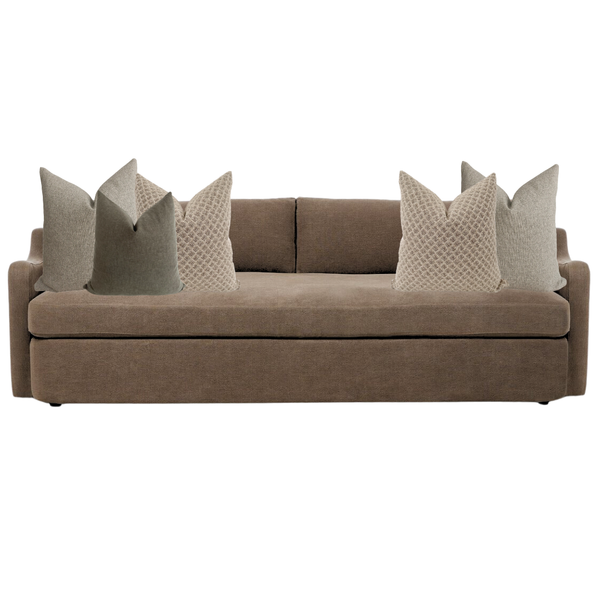Brown sofa with decorative pillows on a white background