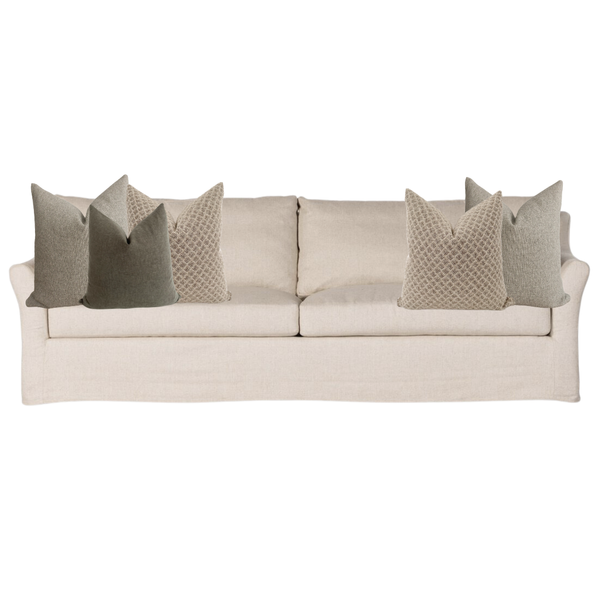 Beige sofa with decorative pillows on a white background