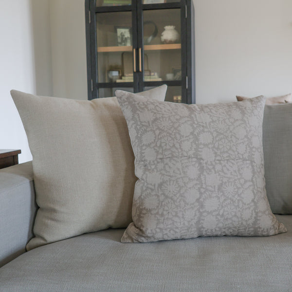 Gray sofa with patterned cushions in a living room setting