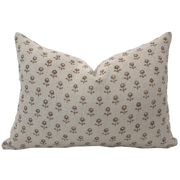 Neutral lumbar pillow cover made of linen with a small brown floral block print pattern and soft, textured finish.