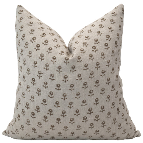 Neutral linen pillow cover featuring a small brown floral block print pattern with a soft, textured finish.
