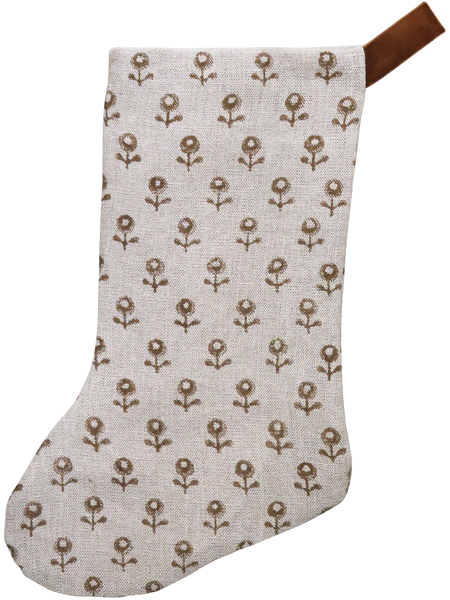 Neutral linen Christmas stocking with a tan floral block print pattern and a brown velvet hanging loop, displayed on a white background.