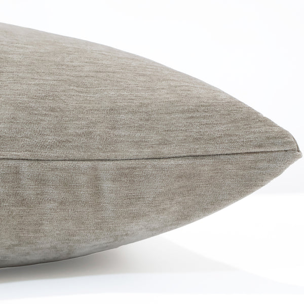Side view of a pillow in ash gray velvet fabric showing its smooth texture, soft sheen, and neatly stitched edge.