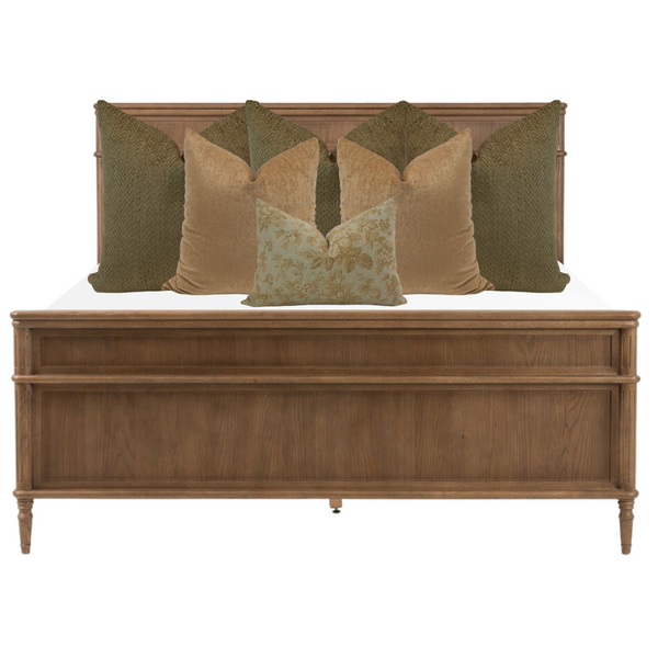 Elegant neutral bed styling featuring olive green and golden velvet throw pillows in layered arrangement on a light beige upholstered bed by Hackner Home.