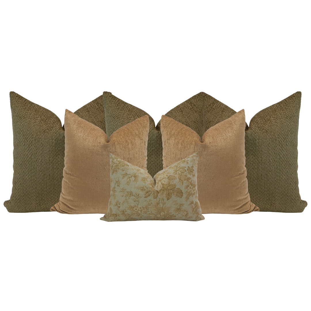 Close-up of Hackner Home Golden Apple pillow combination featuring olive green and golden velvet throw pillows with a floral lumbar pillow in the center.