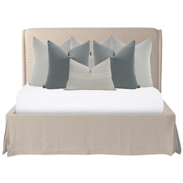 Hackner Home Moonlit Fog bed pillow combo displayed on a neutral upholstered bed with layered gray, blue, and ivory pillows for a serene, modern bedroom design.
