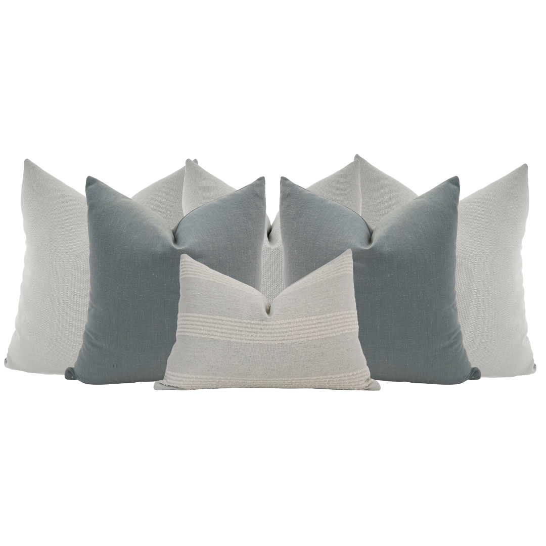 Hackner Home Moonlit Fog pillow set featuring layered blue-gray and ivory decorative pillows in a modern, serene neutral arrangement.