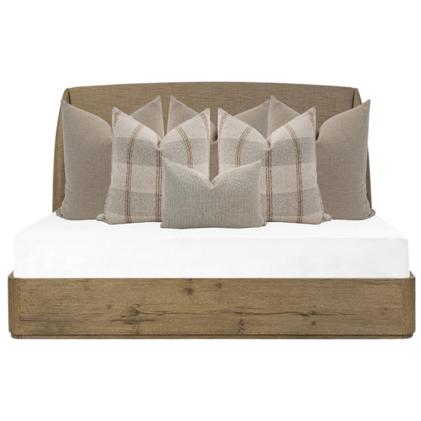 Hackner Home neutral bed pillow arrangement with beige plaid and textured throw pillows styled on a rustic wood platform bed.