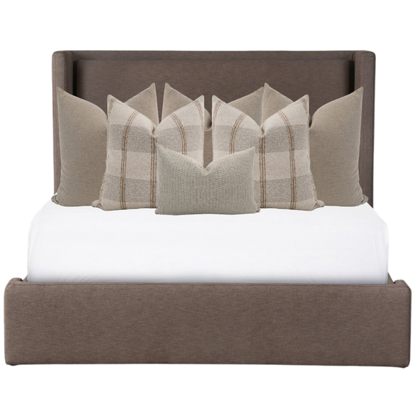 Hackner Home neutral bed pillow combo featuring beige plaid and textured accent pillows styled on a modern upholstered bed frame.