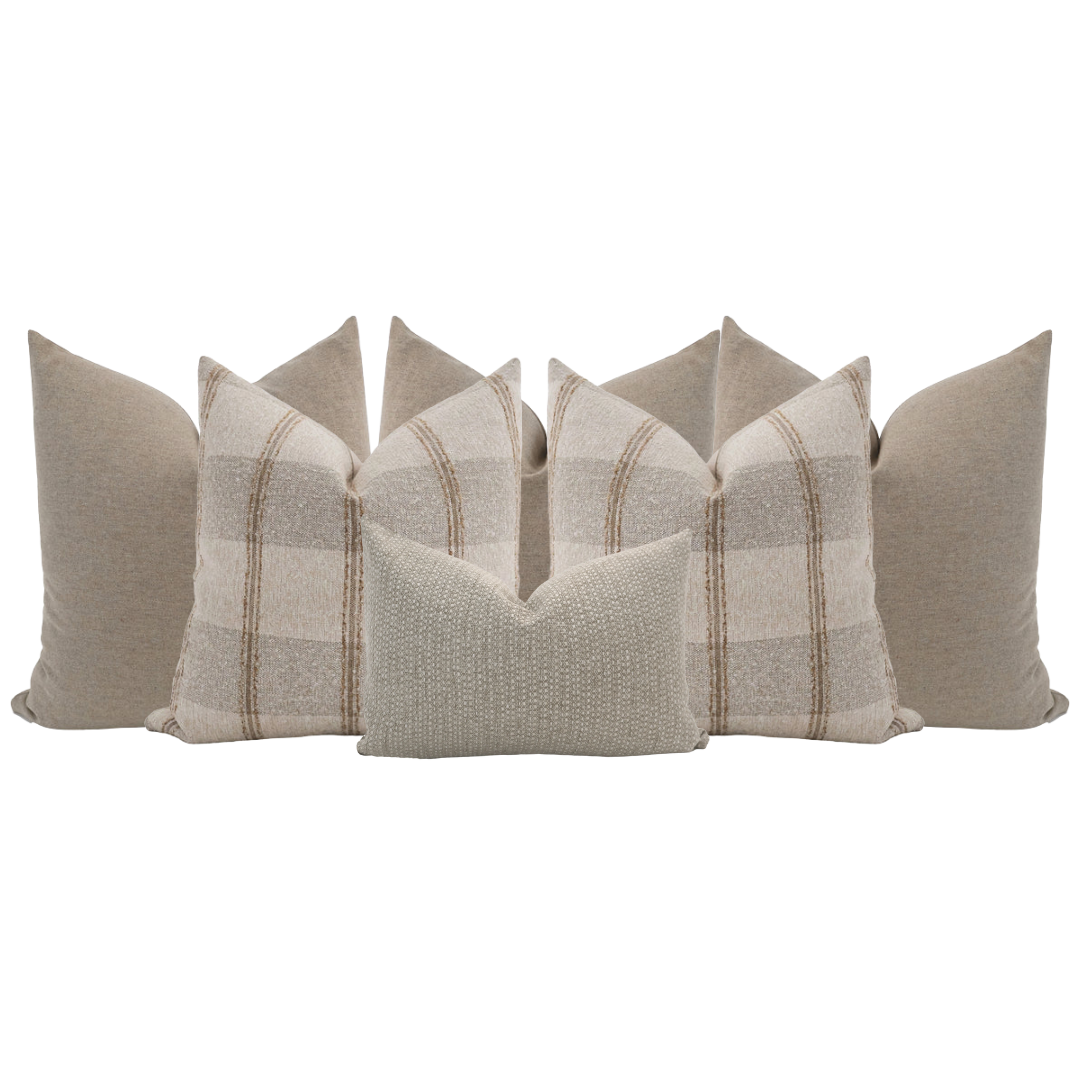 Hackner Home neutral bed pillow set featuring soft beige plaid and textured accent pillows styled for layered bedroom decor.