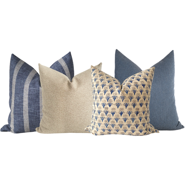 Close-up of a coordinated blue and beige Hackner Home pillow cover set featuring a mix of striped, textured, and floral block print designs for a refined, coastal-inspired look.