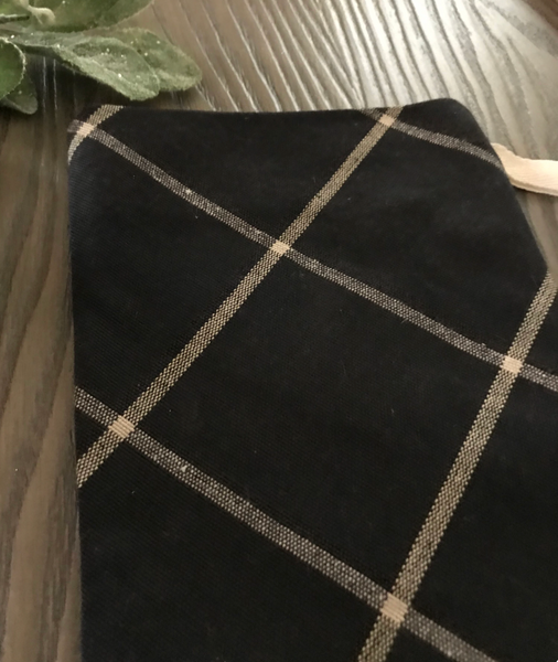 Close-up of black diamond plaid Christmas stocking fabric with beige crosshatch pattern, handmade holiday décor by Hackner Home.