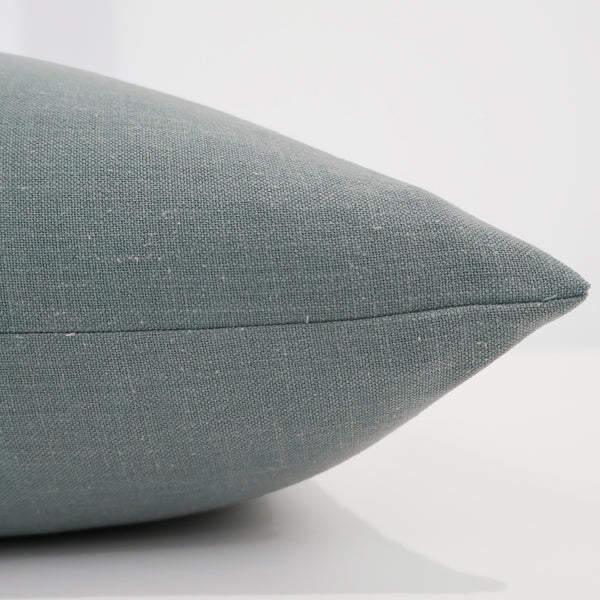 Close-up side view of Hackner Home Blue Drift pillow cover showcasing the fine linen weave, soft blue tone, and precise seam detailing for a refined modern look.