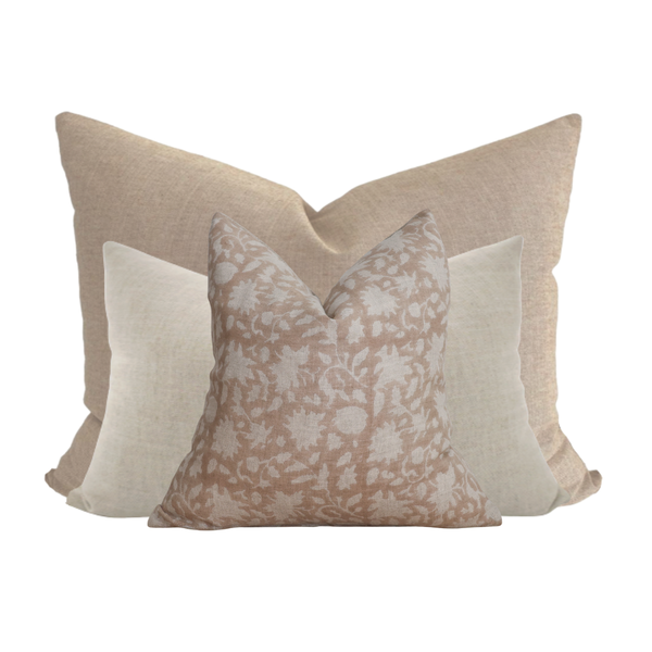 Neutral and blush pillow combination on twin bed by Hackner Home – layered linen and floral pillows in warm beige and cream tones.