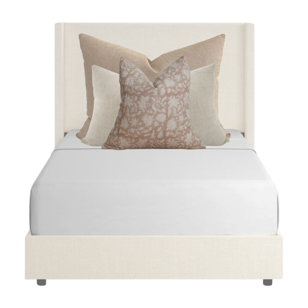 Neutral and blush pillow combination on twin bed by Hackner Home – layered linen and floral pillows in warm beige and cream tones.