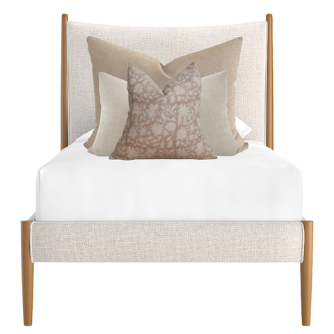 Neutral and blush pillow combination on twin bed by Hackner Home – layered linen and floral pillows in warm beige and cream tones.