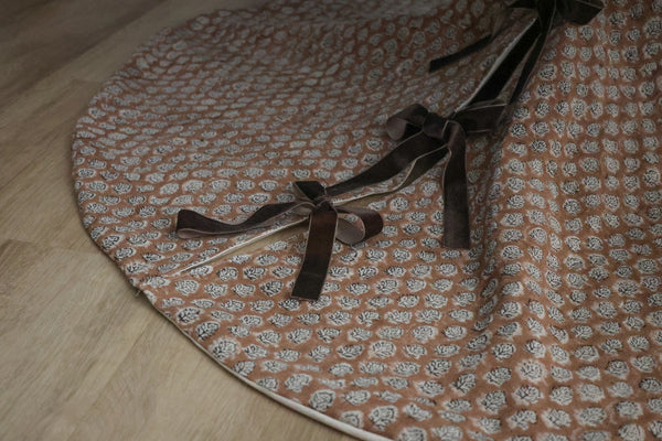 Brick rose block print tree skirt by Hackner Home – handcrafted fabric with velvet ribbon ties in a floral motif.