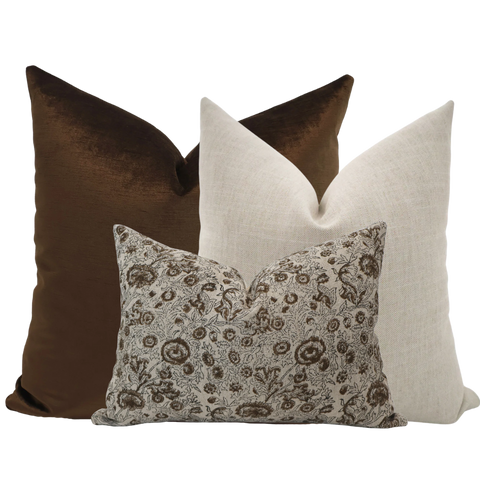 Hackner Home Clara Pillow Cover Set featuring a rich chocolate brown velvet pillow, a soft neutral linen pillow, and a floral block print lumbar pillow in warm brown tones.
