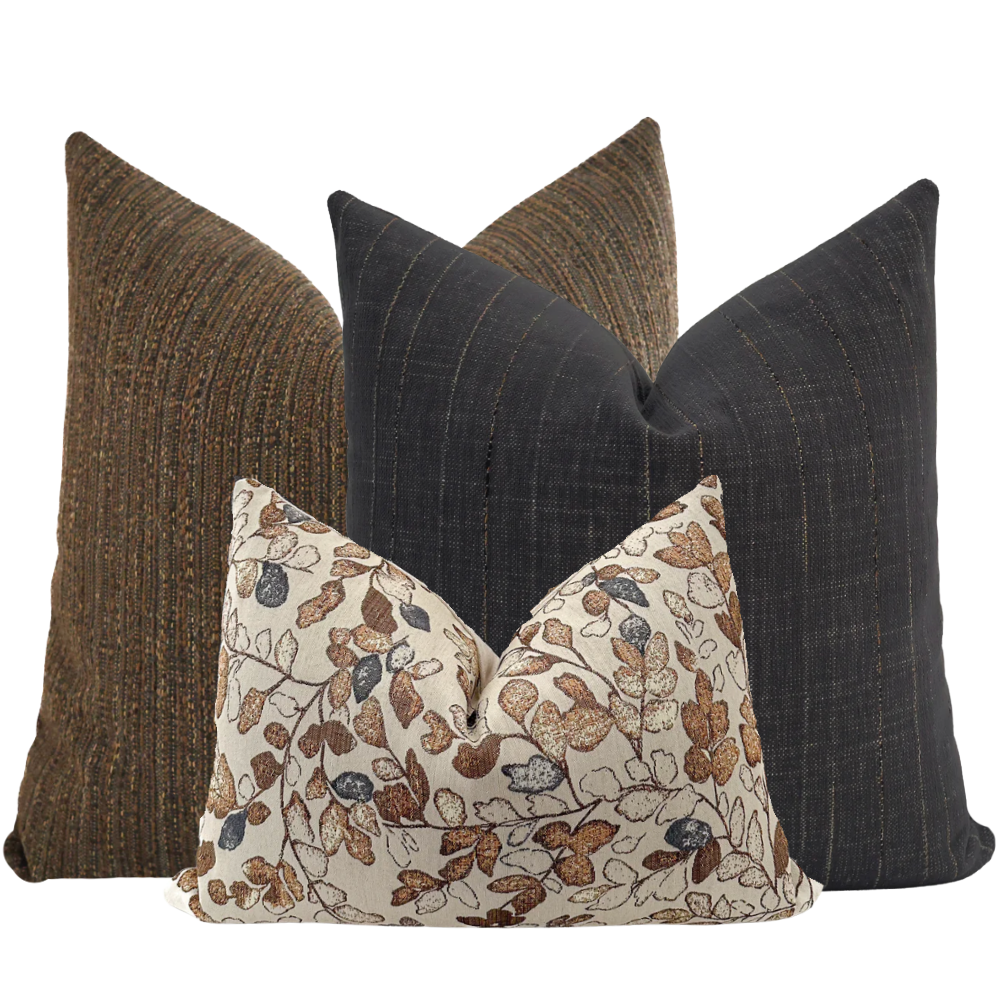 Hackner Home Cottage Harvest pillow cover set featuring a mix of dark brown, charcoal, and cream tones with autumn leaf print and textured woven fabrics for cozy seasonal decor.