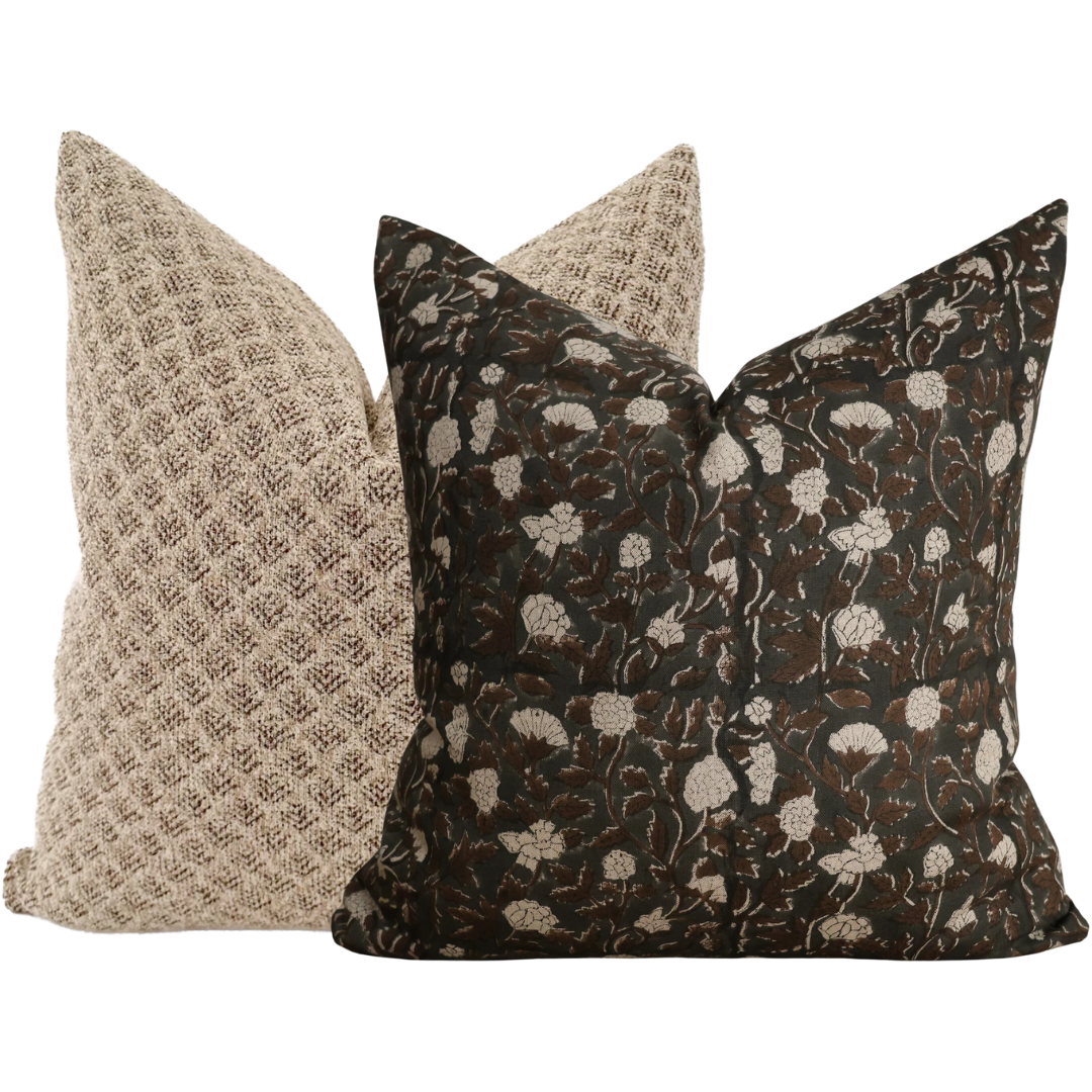 Set of two pillow covers featuring a dark floral block print pillow in brown and cream tones paired with a textured beige pillow.