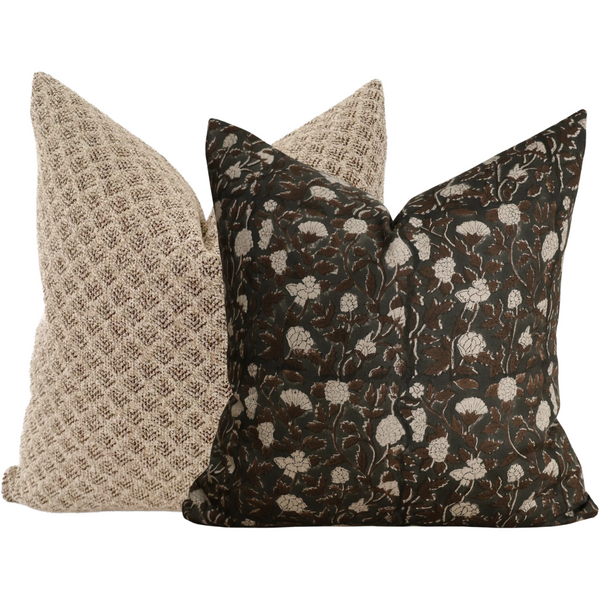 Set of two pillow covers featuring a dark floral block print pillow in brown and cream tones paired with a textured beige pillow.