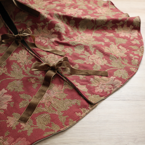 Brick rose block print tree skirt by Hackner Home – handcrafted fabric with velvet ribbon ties in a floral motif.