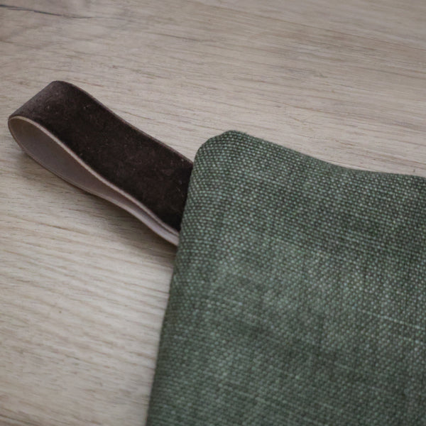 Forest green linen Christmas stocking with a brown velvet hanging loop — elegant and timeless holiday decor by Hackner Home.