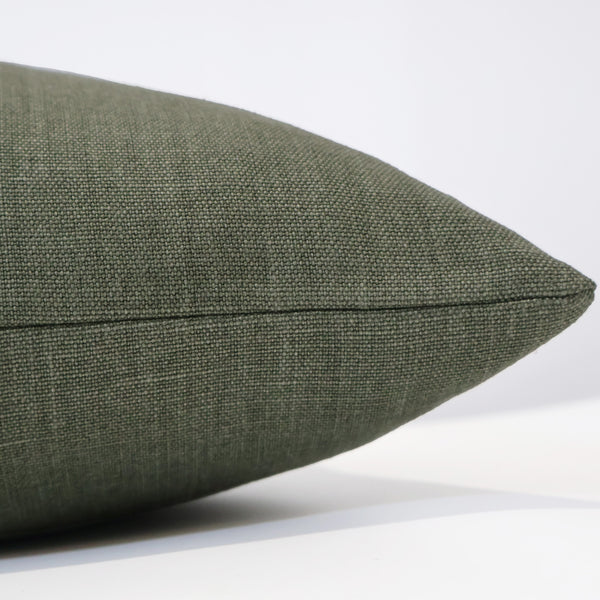 Side view of Hackner Home Forest Estate linen pillow cover in rich forest green, showcasing the finely woven texture and clean stitching detail.