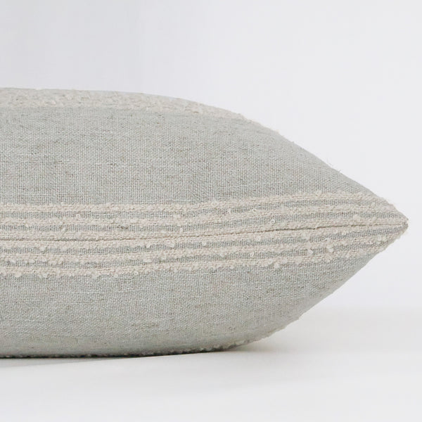 Side view of Hackner Home French Grain Sack Blue pillow cover showing textured cream stripes on soft woven fabric for a rustic farmhouse style.