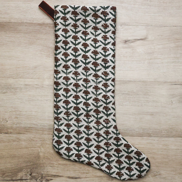 Hackner Home Holly Block Print Large Minimal Christmas Stocking featuring a hand-printed brown and green floral pattern on natural linen with a velvet hanging loop.
