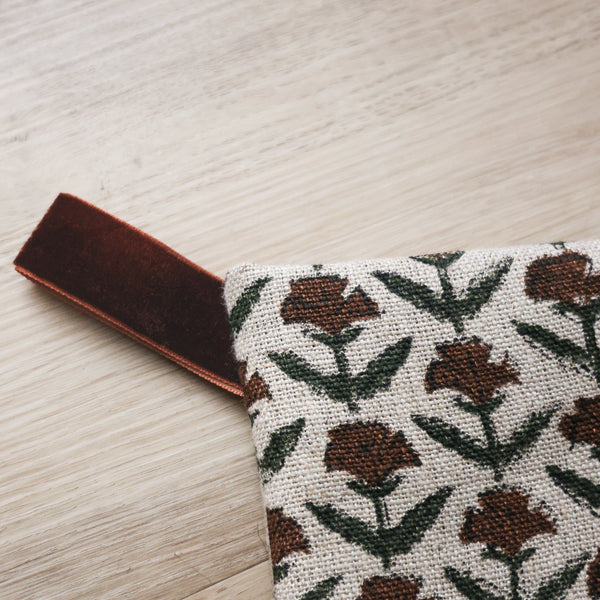 Hackner Home Holly Block Print Large Minimal Christmas Stocking featuring a hand-printed brown and green floral pattern on natural linen with a velvet hanging loop.