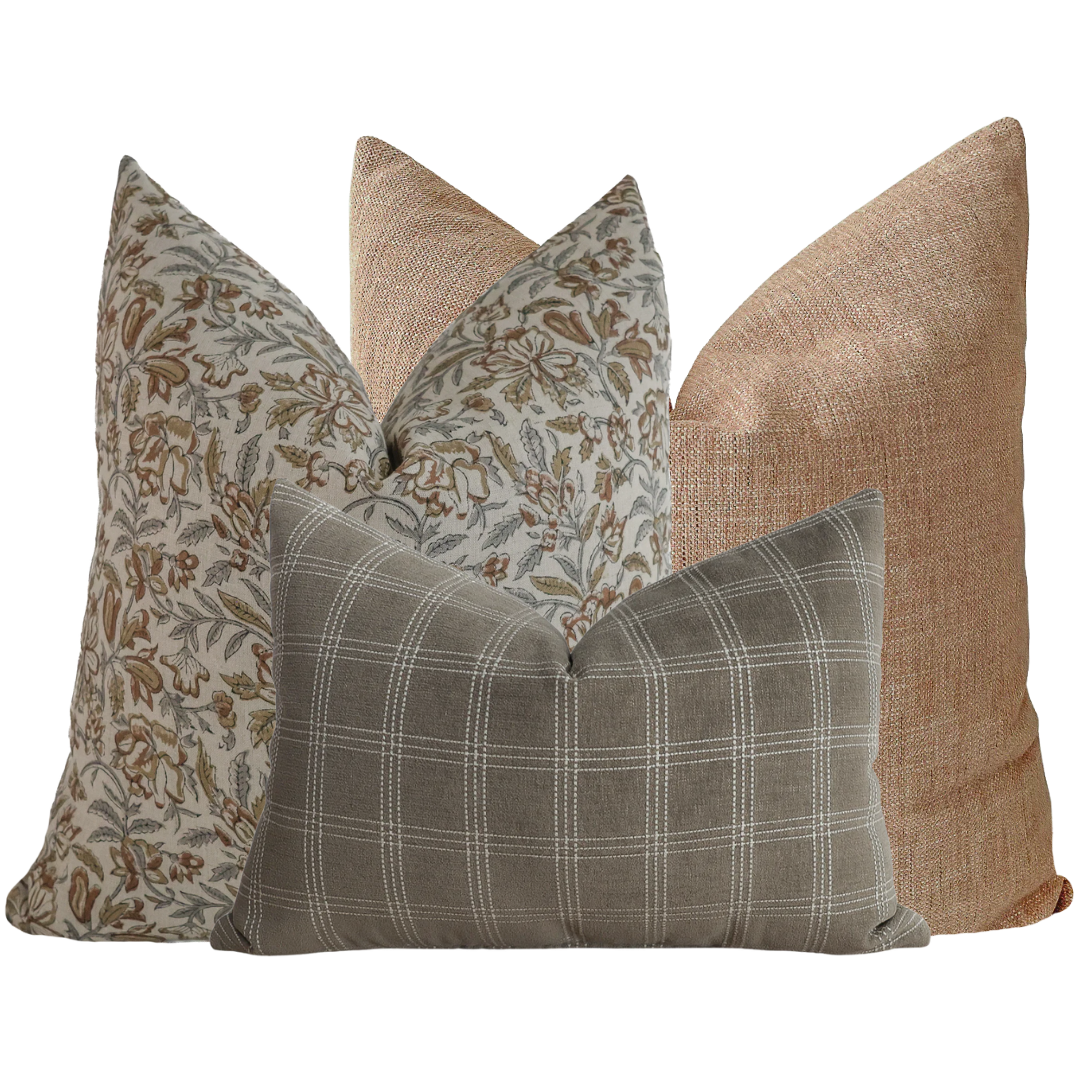 Hackner Home Just Lovely pillow cover set featuring a mix of floral, plaid, and textured blush-toned pillows in warm, earthy hues.