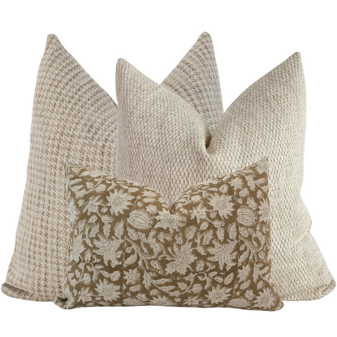 Hackner Home Lightly Toasted pillow cover set featuring a mix of warm beige and tan woven textures with a floral lumbar pillow in front.