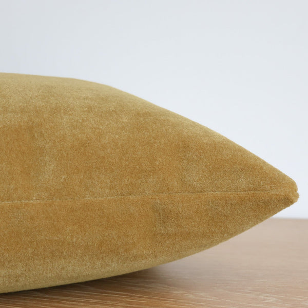 Side view of a butterscotch yellow mohair pillow cover showing its soft, velvety texture and neatly stitched seam.