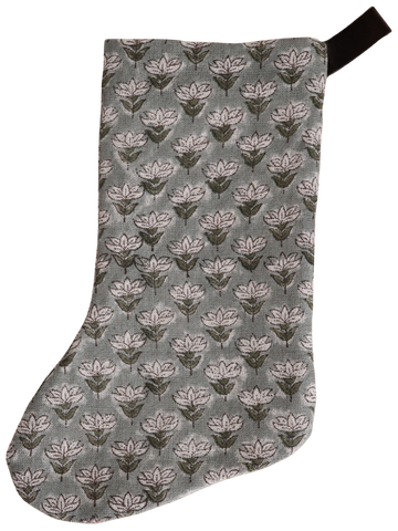 Muted blue floral block print Christmas stocking with hand-stamped design and dark velvet hanging loop, featuring a soft linen texture and boho-inspired pattern.