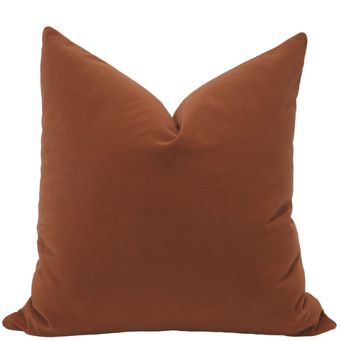 Front view of a pumpkin orange velvet pillow cover with a smooth, soft texture and plush tailored shape.