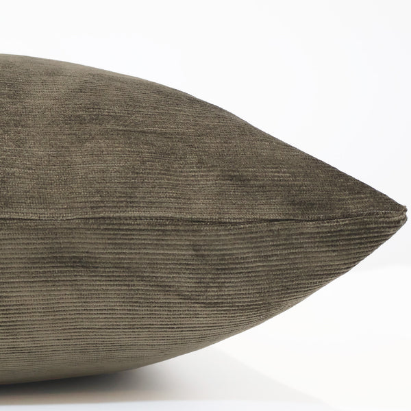 Side view of a sablewood brown velvet pillow showing its soft ribbed texture, plush structure, and finely stitched seam.