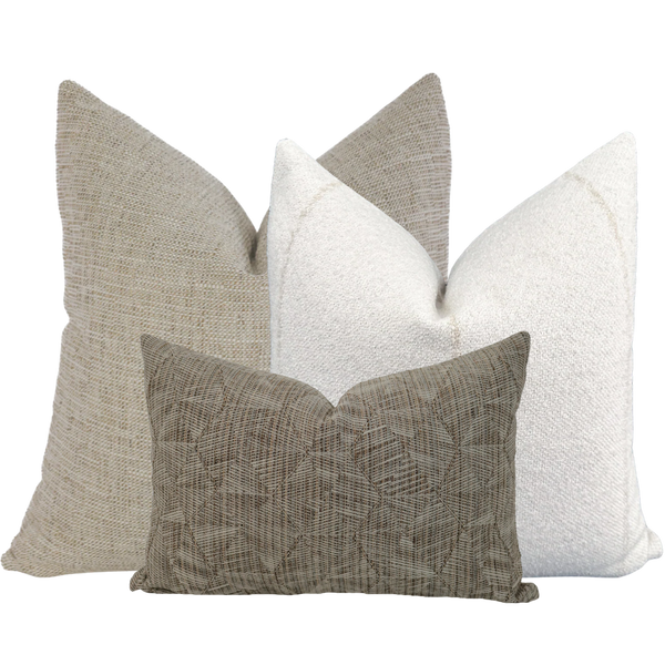 Hackner Home Sand Petal outdoor pillow cover set featuring neutral textured fabrics in tan, cream, and taupe tones, styled for a modern, natural outdoor look